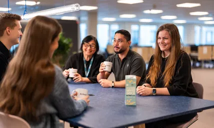 people sitting at a table in an office